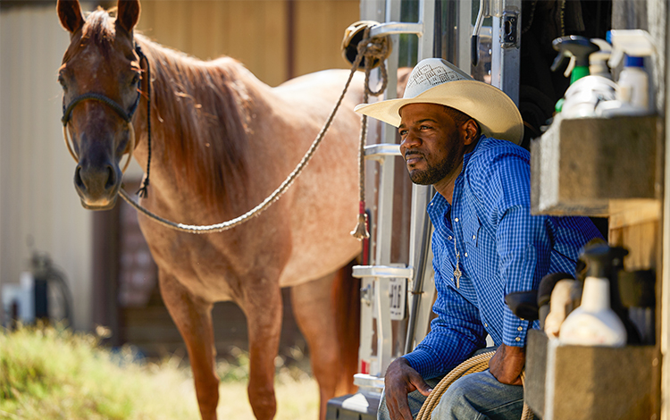 Stephan Robinson sitting near horse 